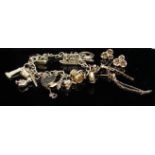A 9ct gold charm bracelet, hung with various charms including cable car, harp etc, 25.