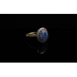 A black opal and diamond ring, stamped 18ct. Size R, 3.
