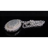 A Victorian silver oval locket, engraved bird decoration, hung on chain,