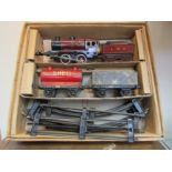 A Bing 0 gauge tinplate clockwork goods set comprising 0-4-0 locomotive and tender,