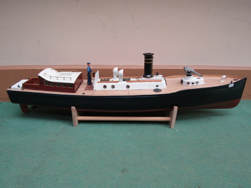 A hand built model of a picket boat with figure at wheel, on stand,