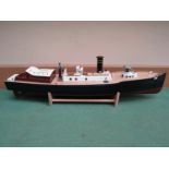 A hand built model of a picket boat with figure at wheel, on stand,