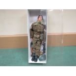 An Action Man British World War II Infantryman figure with brown flocked hair in jacket, trousers,