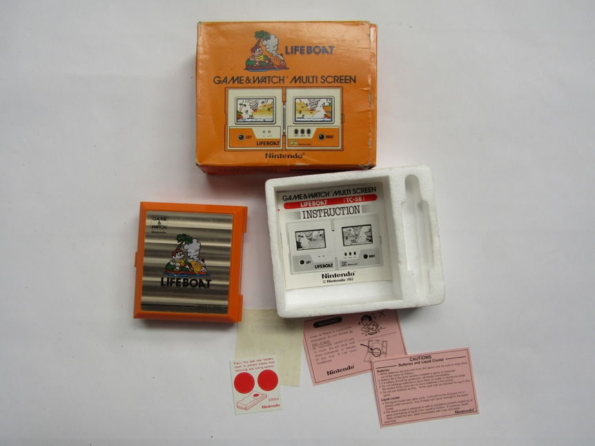 A boxed Ninendo Game & Watch Lifeboat multi screen hand held computer game