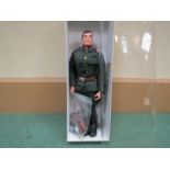 An Action Man Russian Infantryman figure in jacket, trousers, boots, belt and fur hat with badge,