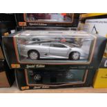 Two boxed Maisto 1:18 scale diecast cars,
