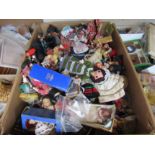 A large box of assorted costume dolls