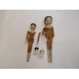 Two wooden peg dolls with hinged joints, 29cm and 26cm tall,