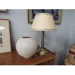 A cream pierced bulbous table lamp together with another cream shaded table lamp