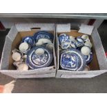 Two boxes of blue and white willow pattern transfer ware
