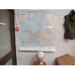A desk globe together with a laminated wall map of Europe,