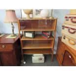 A 1960's teak cabinet / bookcase with sliding glass doors,