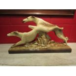 A French ceramic figure of racing greyhounds, stamped Le Maneau, 53cm long