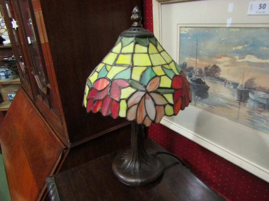 A Tiffany style table lamp with stained glass floral shade, tree form base, 36cm high overall