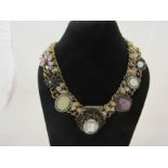A vintage yellow metal necklace with a row of clear glass stones and central mounted cut example,
