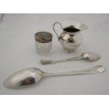 An early 20th Century silver cream jug, lidded dressing table pot and two spoons (4)