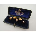 Five assorted shirt studs including gold