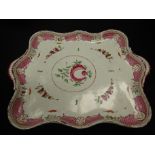 A late 19th/early 20th Century creamware two-handled tray of wavy rectangular form, painted in pink,