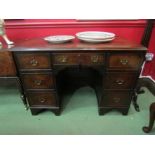 A George II style crossbanded figured walnut twin pedestal desk of seven drawers with working