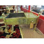 A Syrian brass charcoal brazier with single drawer and twin handles on raised legs, 39cm x 66cm x
