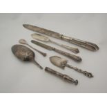 A selection of silver cutlery including broken spoon and knives, silver pencil case
