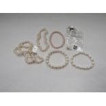 A pearl necklace, four pearl bracelets and a pair of pearl drop earrings
