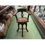 A late Victorian child's high seat revolving height adjustable captain's chair with cane seat
