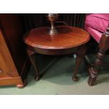 A circa 1920 mahogany circular top coffee table on cabriole leg supports to pad feet