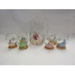 A lemonade jug and matching set of six glasses with painted lady design