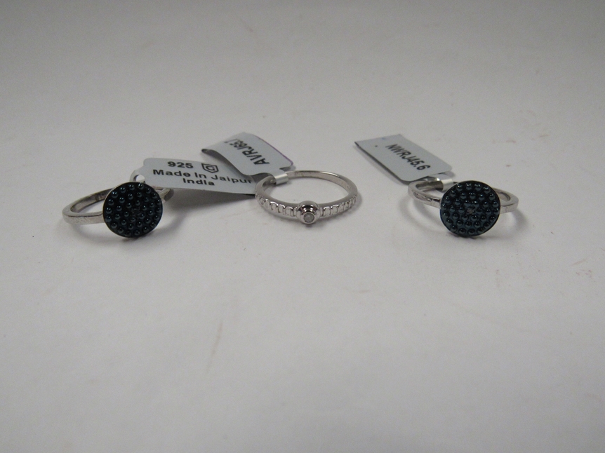 Three Sterling silver rings including blue and white diamond examples, with certificates