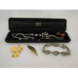 A selection of costume jewellery incluidng mosaic panel bracelet, gold bar brooch, gilt brooches,