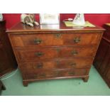 A Circa 1800 crossbanded and figured walnut chest of four long drawers having brass swan handles