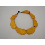 An orange seven segmented necklace