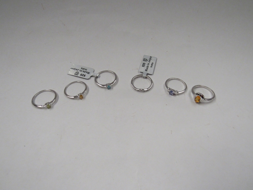 Six Sterling silver rings including Tanzanite, fire Opal, diamond, yellow sapphire, blue apatite and