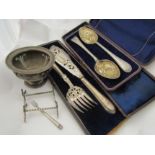 A cased silver plated fish knife and fork, cased plated spoons with ornate bowls, plated knife rests