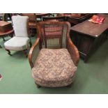 A pair of 1920's bergere armchairs with carved back rest over cabriole feet