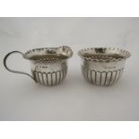 A James Deakin & Sons silver cream jug and sugar bowl with semi-gadrooned bodies and wavy rims,