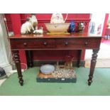 A Circa 1860 mahogany writing/side table the two frieze drawers over turned and tapering leg