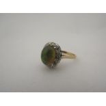 A lady's 9ct gold and opal cabochon ring