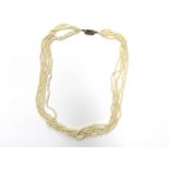 A five row seed pearl necklace with gold and hair panel clasp, unmarked,