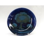 A William Moorcroft 'Moonlit Blue' pattern charger with tree design,
