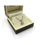 An 18ct white gold diamond pendant 0.