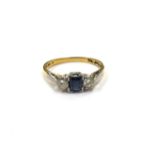 A gold ring with central square cut sapphire flanked by diamonds, stamped 18ct/plat. Size Q, 2.