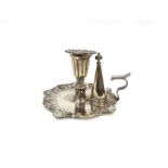 A Robert W Smith silver chamber stick, shell and scrolled edge, with candle insert and snuffer.