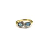 An 18ct gold pale blue stone and diamond ring. Size L, 3.