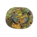 A Majolica style plate with lobster, snail and frogs design in relief,