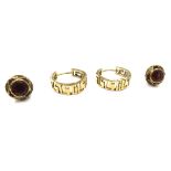 A pair of 14ct gold greek key design hoop earrings and a pair of garnet stud earrings,