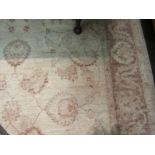A wool cream carpet, beige foliate border and central pattern, 215cm x 155cm