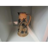 A Royal Doulton stoneware jug with applied leaf design, 26cm tall