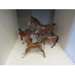 A Beswick horse, two foals and one other (not Beswick)